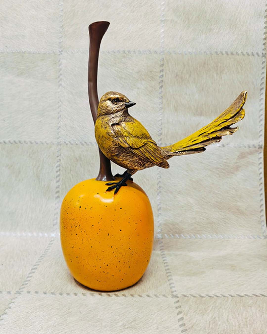 Small Yellow Bird on Round Orange Fruit Statue