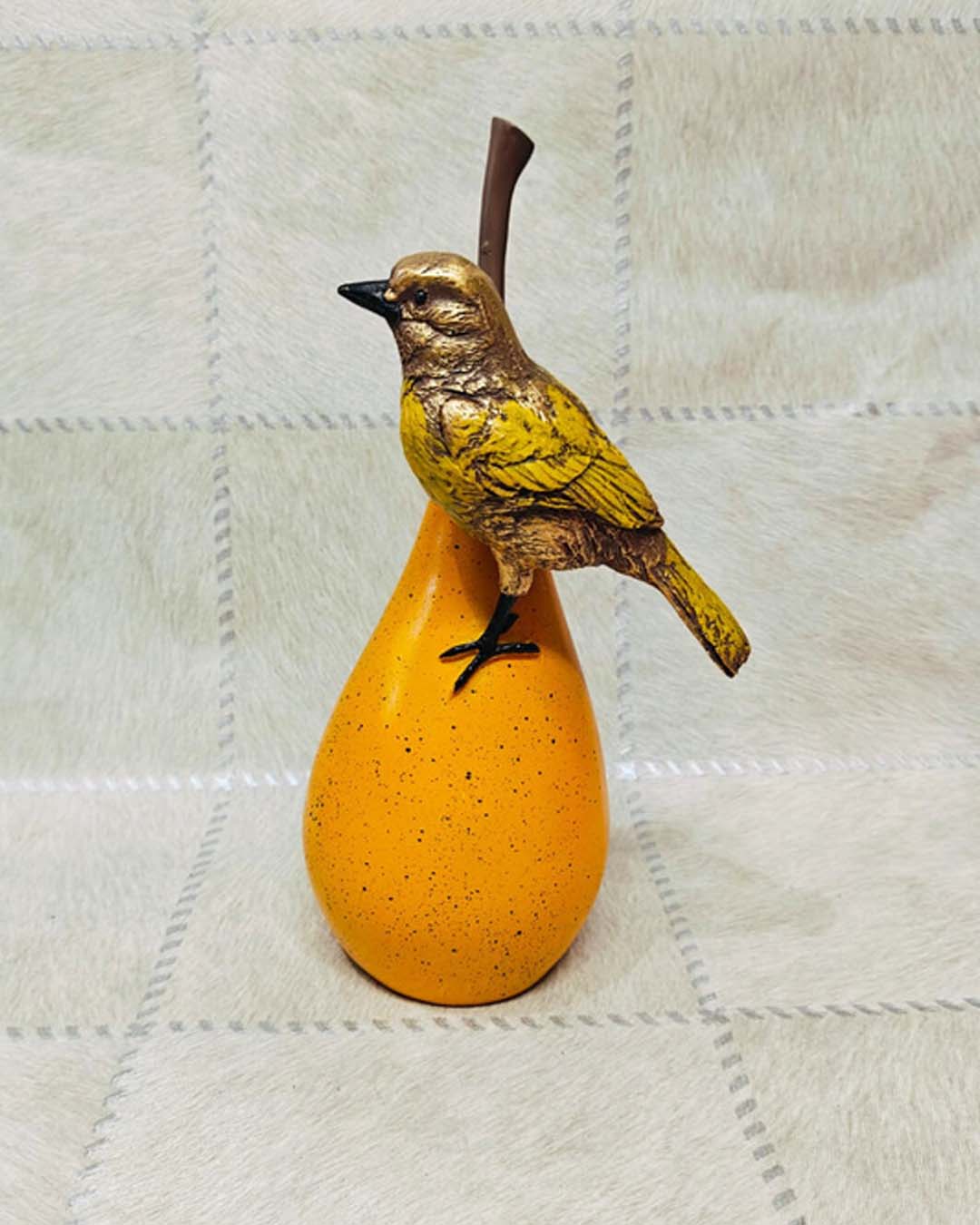 Small Yellow Bird on Round Orange Fruit Statue