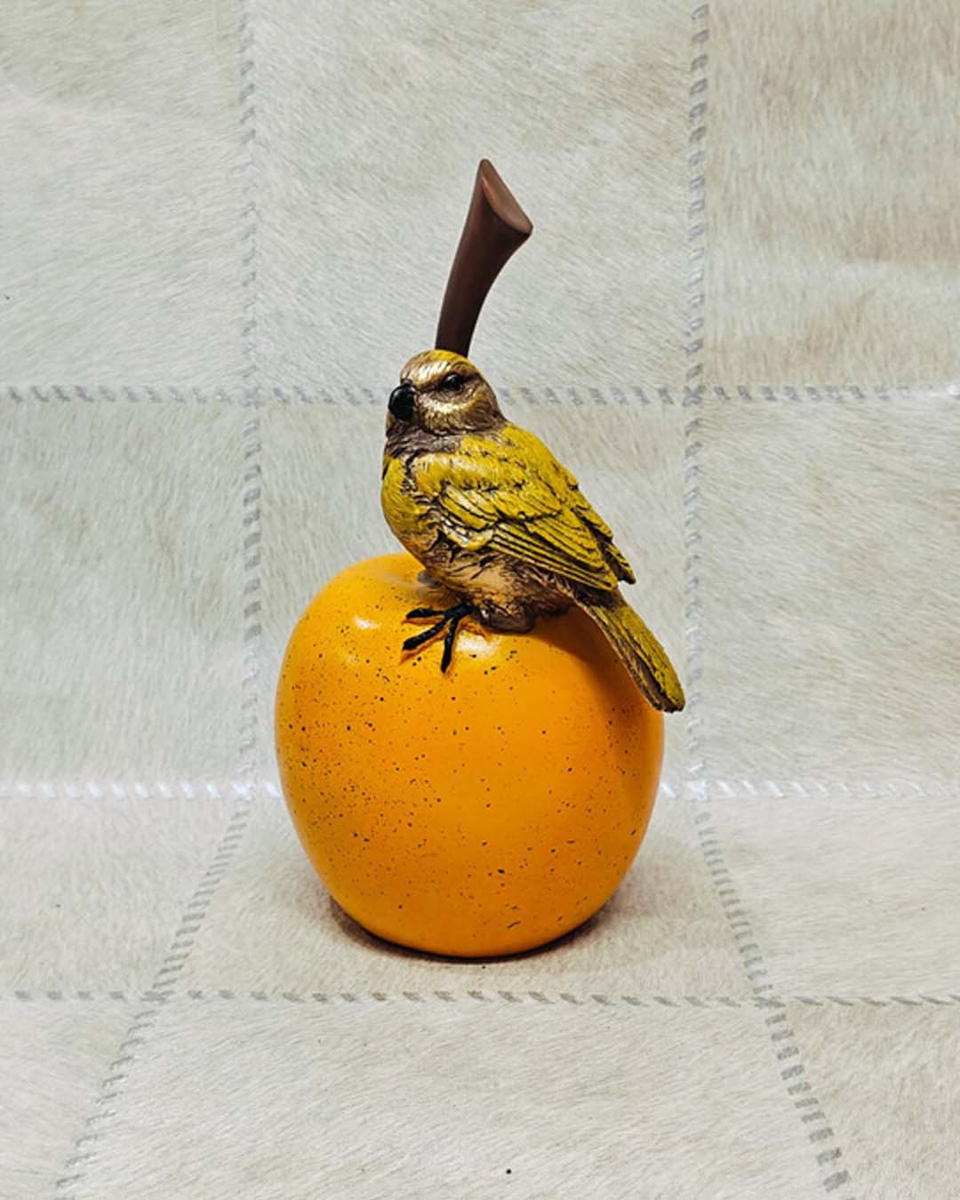 Small Yellow Bird on Round Orange Fruit Statue